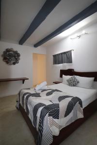 Postel nebo postele na pokoji v ubytování Hotel Mittoz Holbox