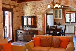 a living room with a couch and a dining room at Julieta Stone Villa in Andip&aacute;ta Er&iacute;sou