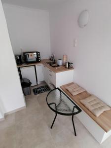 a small kitchen with a table and a chair at Vivaria House in Paleokastritsa +12 photos