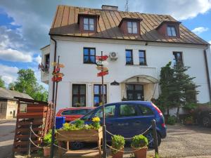 a house with a car parked in front of it at chatky Pension Doctor in Choustníkovo Hradiště