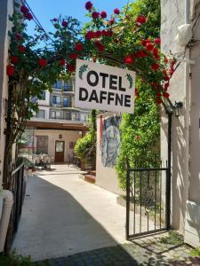 a sign that reads otel darma on a building with flowers at Daffne Otel in Çanakkale