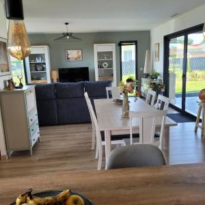 a kitchen and living room with a table and chairs at Pause 24 in Saint-Laurent-des-Vignes +13 photos