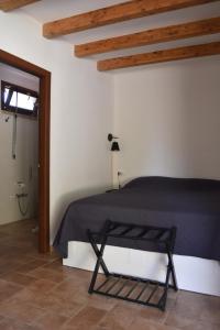 a bedroom with a bed in a room with wooden ceilings at Oltremare in Riparbella +37 photos