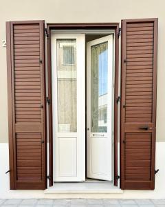 a pair of doors on the side of a building at La Dimora del Corso appartamento in Campi Salentina
