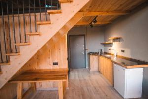 a kitchen with a wooden staircase with a wooden table at Bucci Suit in Çamlıhemşin