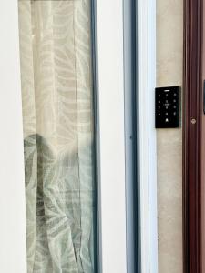 a glass door with a window with a curtain at La Dimora del Corso appartamento in Campi Salentina +85 photos