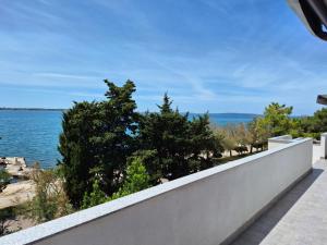 a view of the water from the balcony of a house at Apartments "Mulo" beachfront in Vrsi