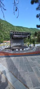 a bench with a stage in a park at Hotel International in Băile Herculane