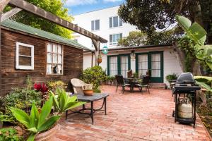 an outdoor patio with a table and a grill at Redwood Hollow Cottages in San Diego