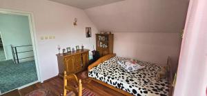 a bedroom with a bed with a black and white comforter at La mama Miha in Agigea