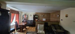 a living room with a table and a dining room at La mama Miha in Agigea