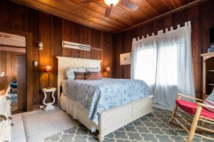 a bedroom with a bed and a window at Redwood Hollow Cottages in San Diego