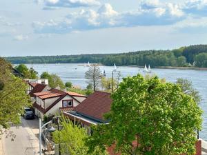 a town with a view of a river and boats at Forest & Lake Mikołajki in Mikołajki