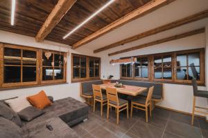 a living room with a couch and a table at Romantik Chalet in Zedlitzdorf