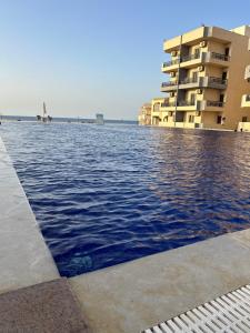 a swimming pool in front of a building at Blue Bay Village- Private Chalet in Marsa Matruh