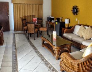 a living room with a couch and chairs and a table at HOTEL MISION SANTA MARIA in San Quintín