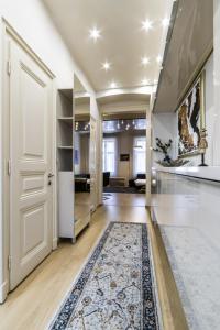 a hallway with a white door and a rug at Andrássy Str. Luxury Apartment in Budapest