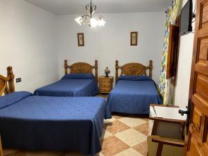 Postel nebo postele na pokoji v ubytování Hostal Moraima