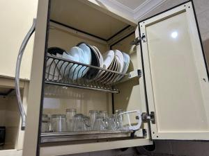 a cupboard with plates and dishes in it at Blue Bay Village- Private Chalet in Marsa Matruh