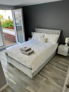 a bedroom with a bed with two towels on it at KM Granton Apartment in Edinburgh