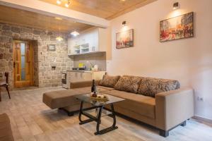 a living room with a couch and a table at Hidden Gem Apartment of the Old Street in Risan
