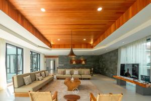 a living room with a couch and a tv at Atsuka Hill View Villa 8 bedrooms with a private heated swimming pool in Bandung