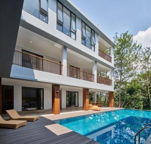 an exterior view of a house with a swimming pool at Atsuka Hill View Villa 8 bedrooms with a private heated swimming pool in Bandung