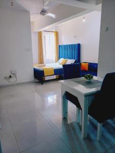 a room with a couch and a table and a bed at Medzam Homes Spacious Newly Furnished Studio in Mombasa
