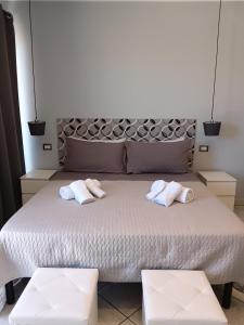 a bedroom with a bed with two towels on it at Il sogno delle rose in Nettuno