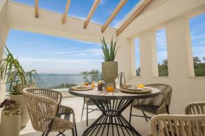 a patio with a table and chairs with a view at Villa Vilielmini Paxos in Gaios