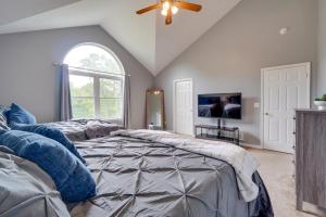a bedroom with a bed and a ceiling fan at 1 Mi to Lakes Family Pocono Home with Fire Pits! in Long Pond