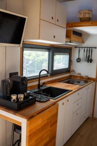 a kitchen with a sink and a counter top at Tiny House Ti Nid 4 étoiles in Montain +9 photos