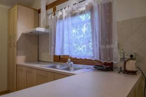 a kitchen with a sink and a window at Pure Nature Haven By The Sea with Hot Tub in Rovinj +40 photos