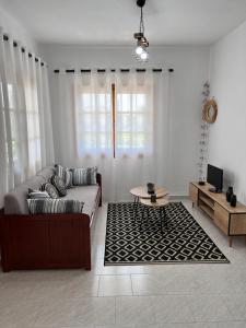a living room with a couch and a table at Sea and Sand House in Orfánion