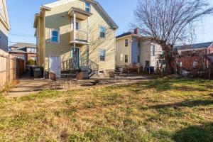 a house with a yard with chairs in front of it at The B&W Haven 5BR Home with yard theater in Bridgeport