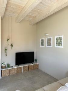 a living room with a flat screen tv on a wall at Podere Mantignano in Faenza