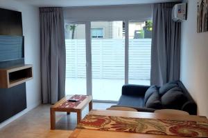 a living room with a couch and a table in front of a window at Rincon del Sol in Pinamar