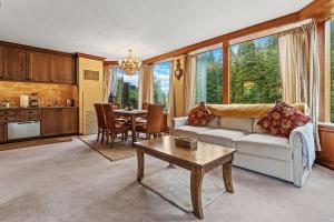 a living room with a couch and a table at Everline Resort & Spa 701 & 703 in Olympic Valley