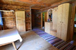 a wooden cabin with a bench in a room at Peintnerhof Almhütte in Innervillgraten