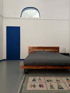 a bedroom with a bed and a blue door at Casa Rara al Mare in Monopoli