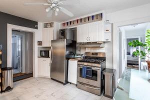 a kitchen with a stainless steel stove and refrigerator at Bella room near downtown Train I-95 & beaches in Stamford