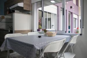 a dining room with a table and white chairs at Andanzas Bahia Uni in Bahía Blanca
