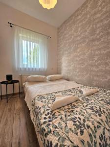 a bedroom with a bed with two pillows on it at Babie Lato in Mrągowo