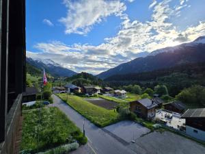 a view of a village with mountains in the background at Suite Tucan in Mühlebach