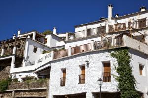 a white building with balconies on the side of it at Casa Carole - 3 Bedroom Luxury Apartment in Bubión