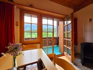 a room with a table and a large window at Suite Tucan in Mühlebach