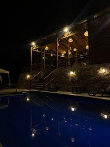 a building with a swimming pool at night at The UFO Shore in Las Núñez
