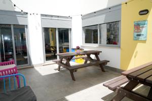 a patio with a wooden picnic table and benches at NEW ART BEACH HOSTEL- Albergue Juvenil in Palma de Mallorca