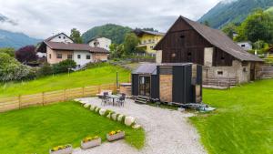 a tiny house in a field next to a barn at Tiny House nähe Millstättersee gemütlich & autark in Oberkolbnitz
