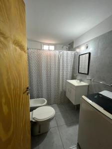 a bathroom with a toilet and a sink at 25 de mayo in Villa Dolores